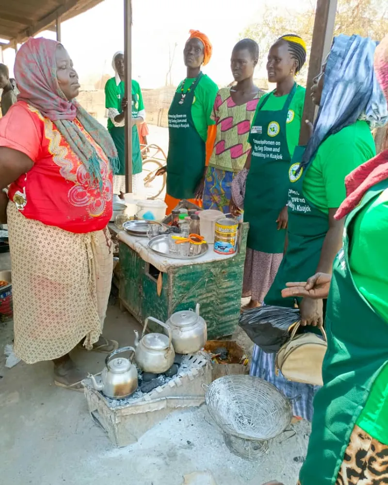 Women in Women for Change aprons at a fuel briquette training